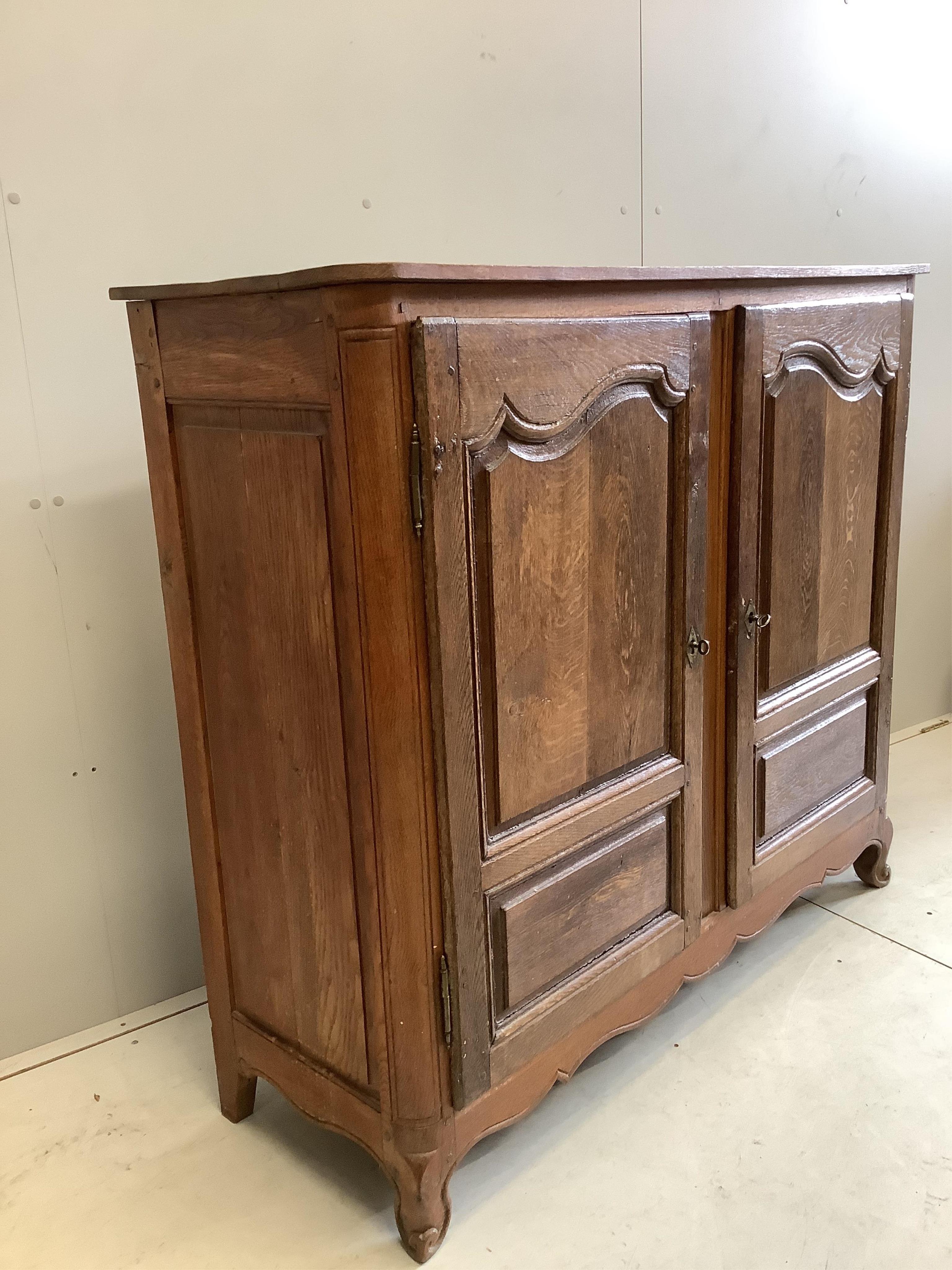An 18th century French oak two door cupboard, width 134cm, depth 46cm, height 118cm